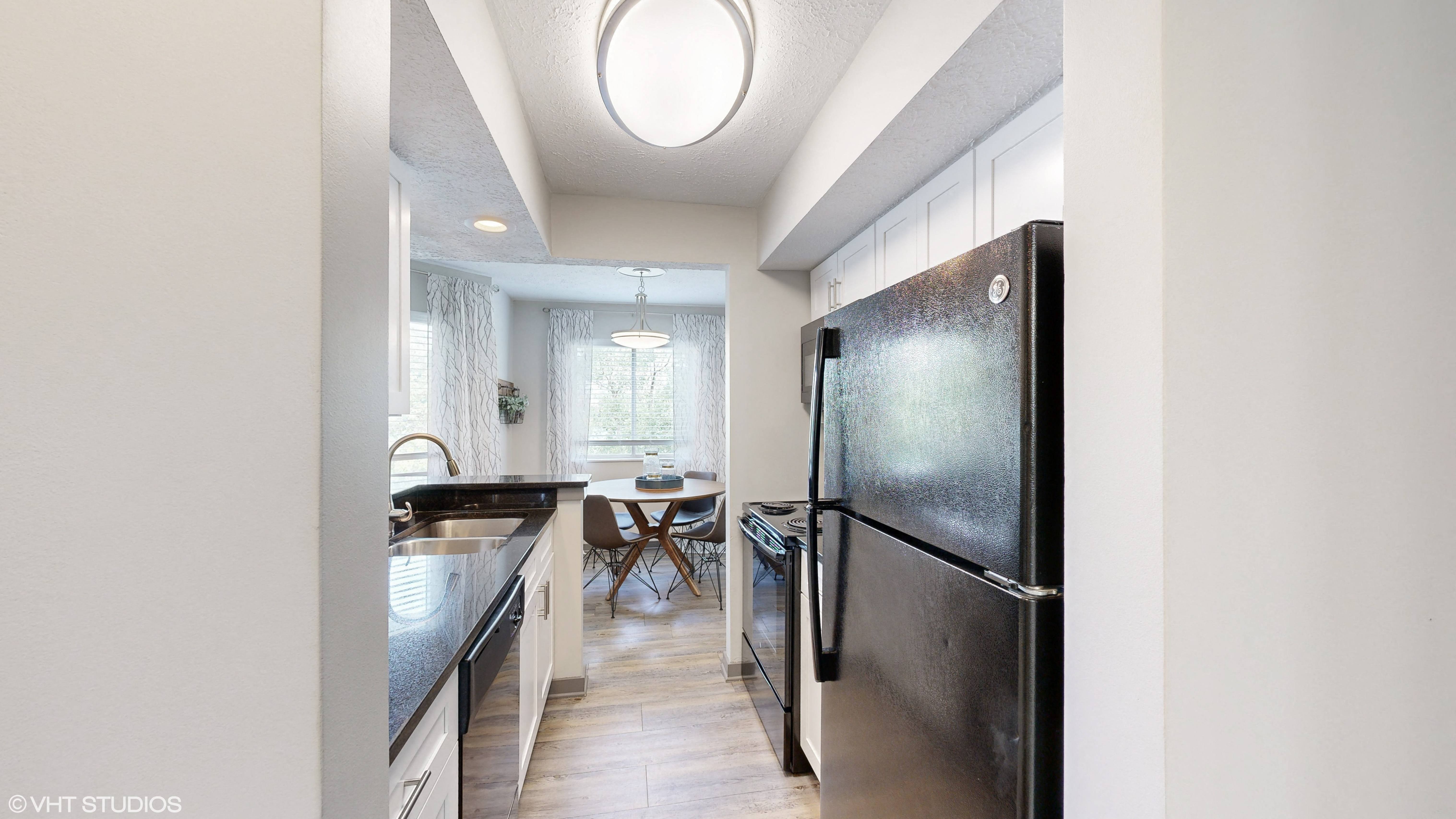 apartment galley kitchen with dining area