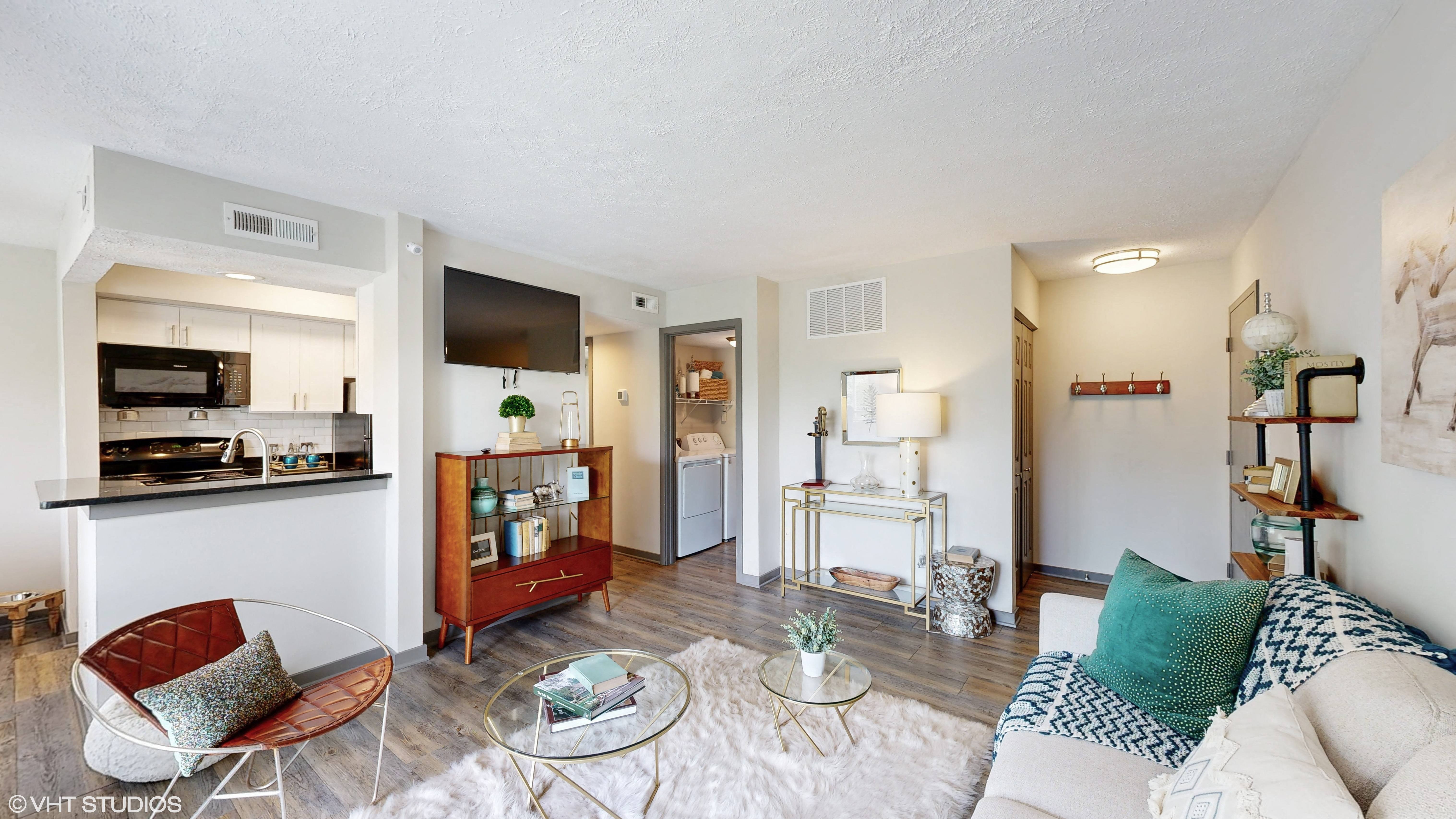 apartment living room with kitchen and laundry area