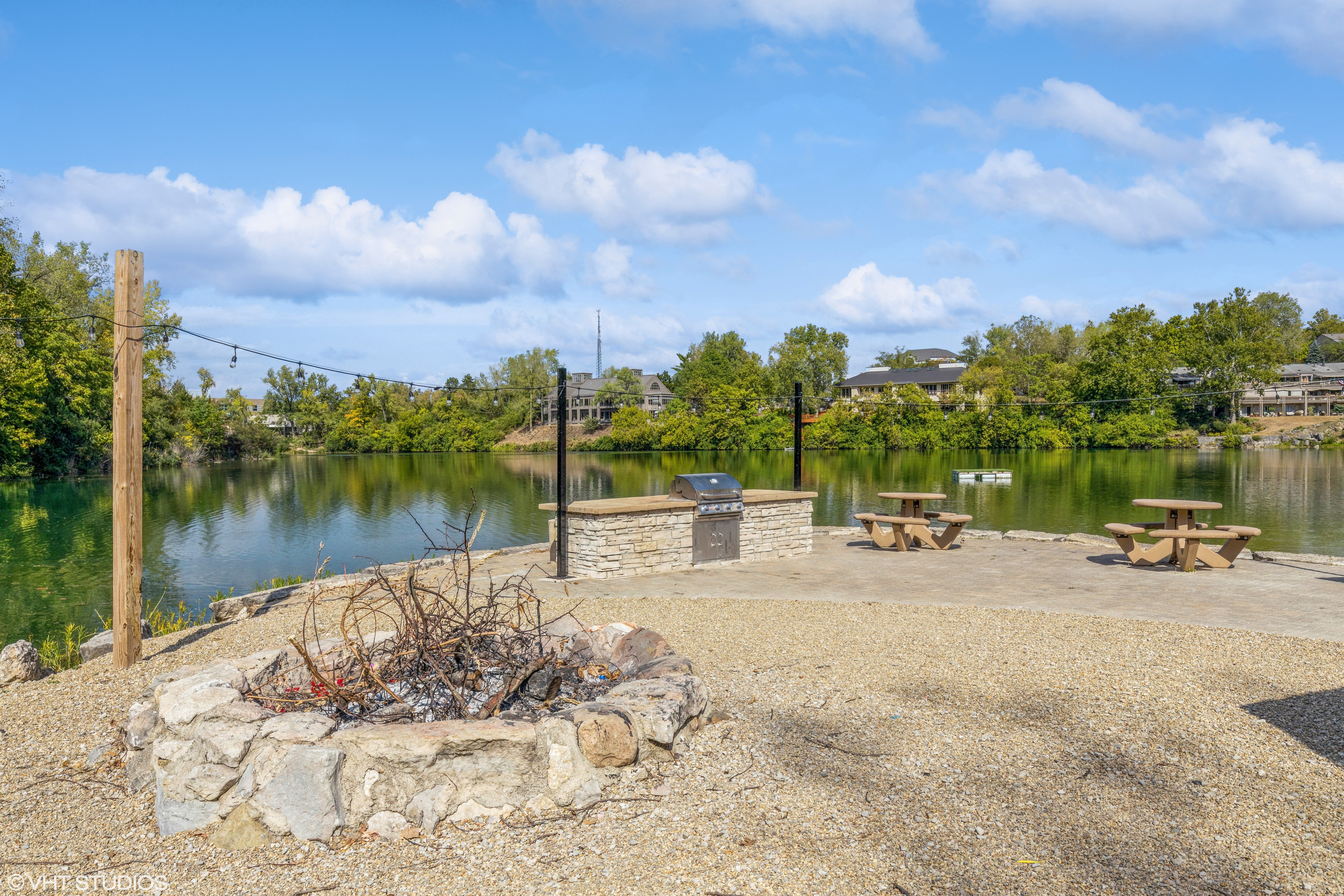 community lakefront firepit and grill area