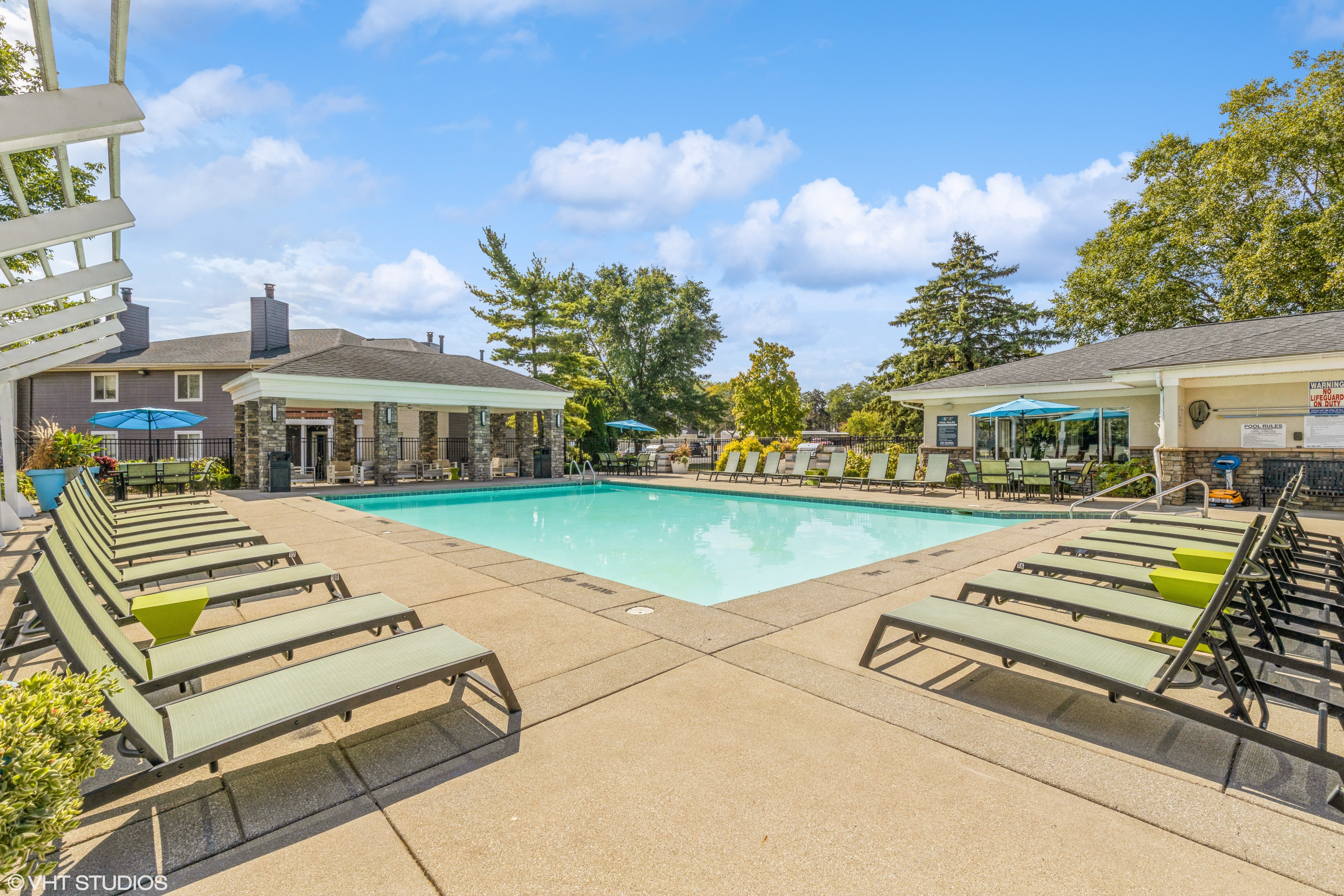 community outdoor swimming pool with lounge chairs 1